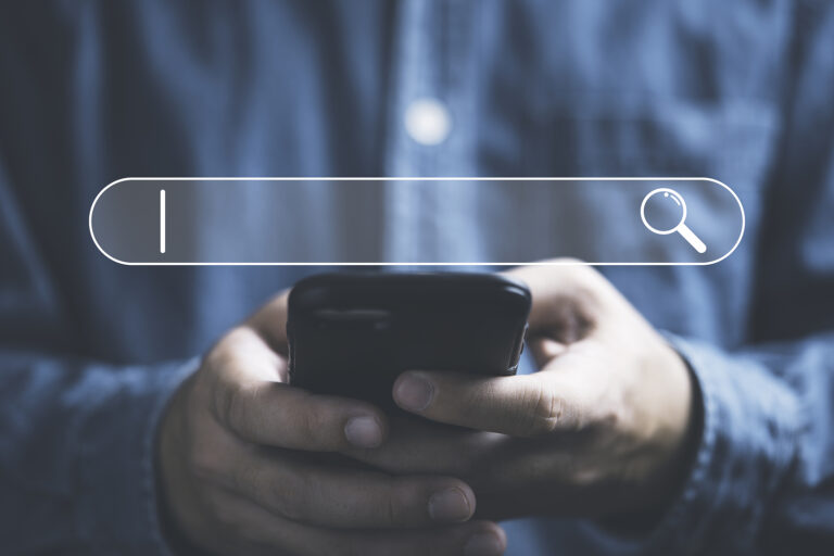 Businessman using smartphone to Google their own business.