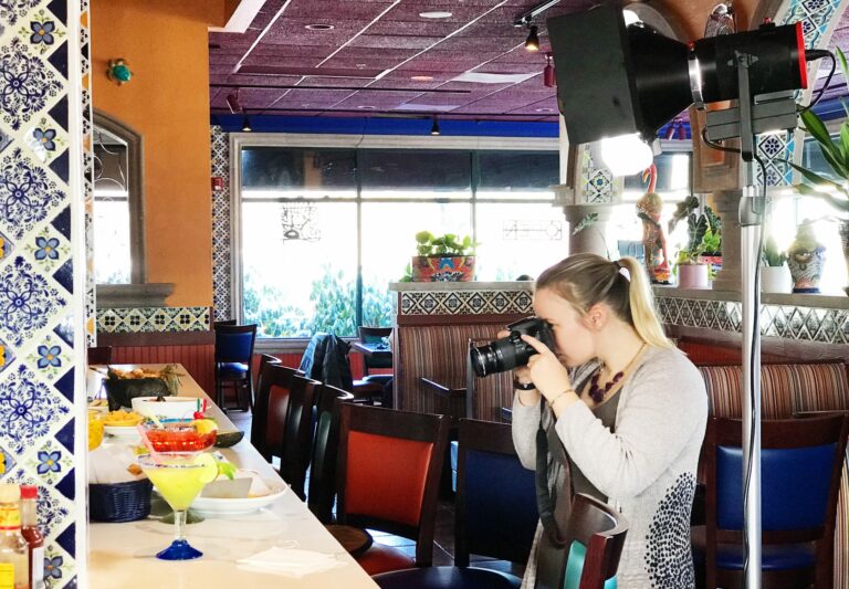 Photographer planning, organizing, and taking pictures during a restaurant's brand photoshoot