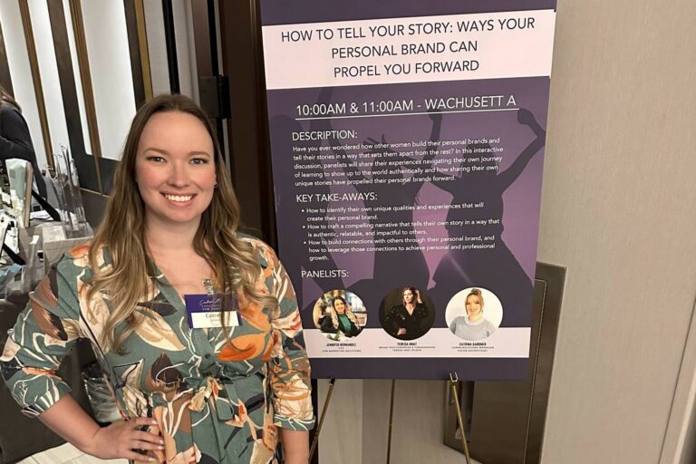 Catrina Gardner posing in front of the personal brand panel.