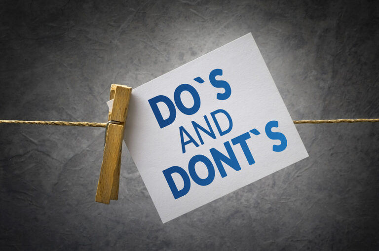 A card reading "Do's and Don'ts" clothe-pinned to a string.