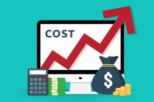 A monitor with a red cost arrow with money in the foreground.