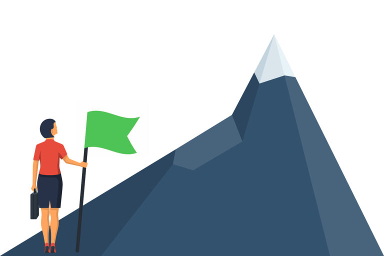 Businesswoman holding green flag and suitcase, looking up at a mountain.