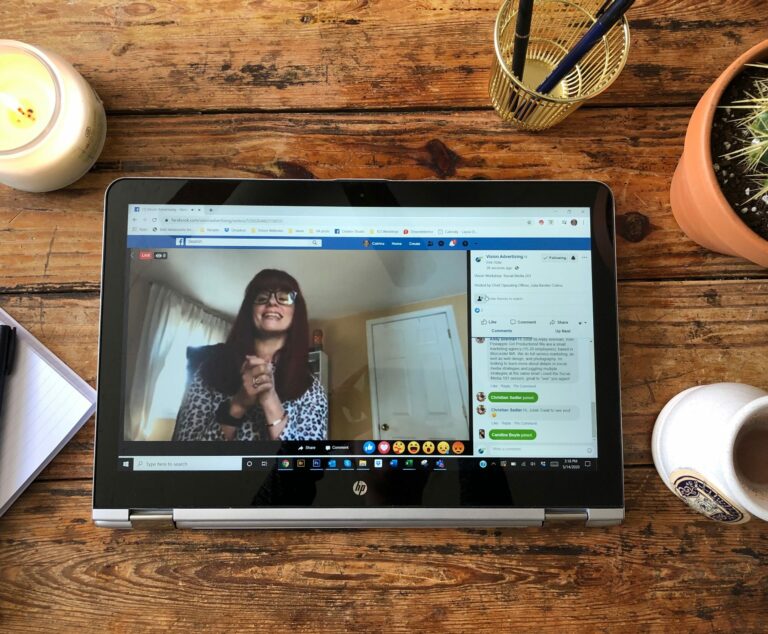 Julia presenting the Social Media 201 webinar on a tablet on top of a wooden table.