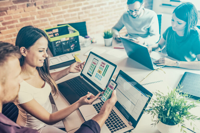 Marketing agency works together in office on computers.