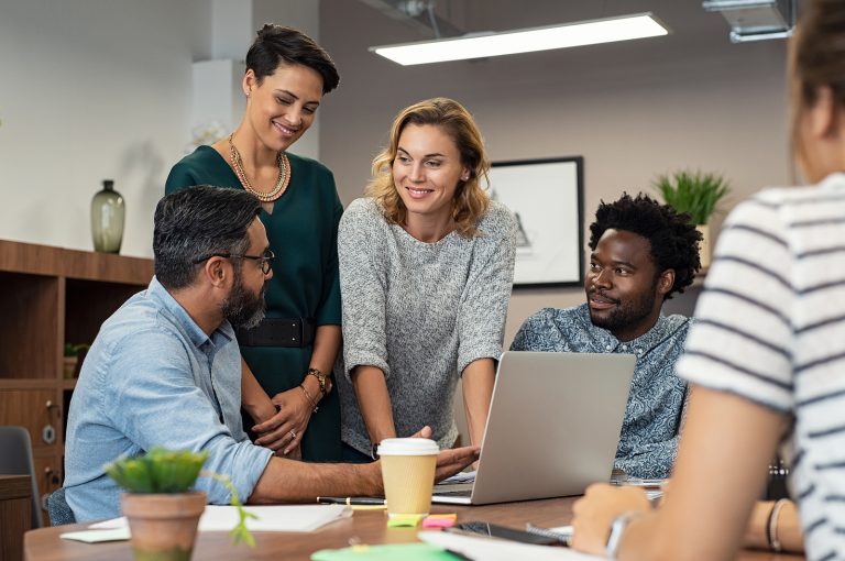 Group of marketers and business people meeting over a laptop.