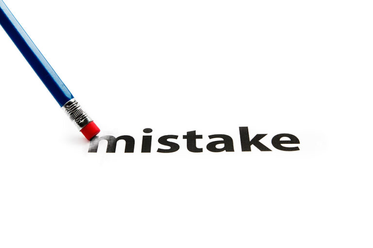 A pencil with eraser is correcting mistake.