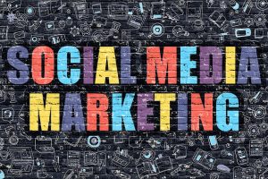 Social Media Marketing in colorful text on black brick background with marketing icons.