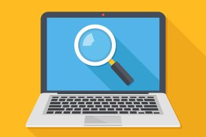 Magnifying glass on the screen on a laptop.