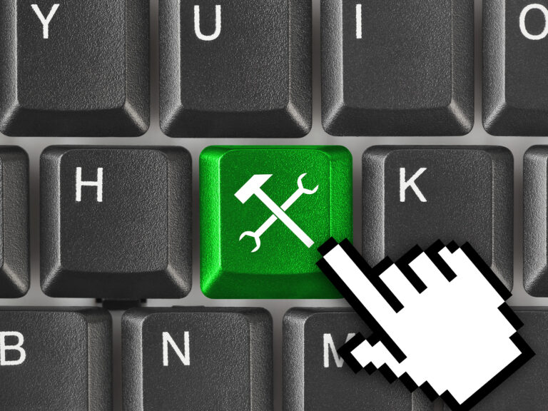 Website maintenance green tool icon on keyboard with mouse hand.