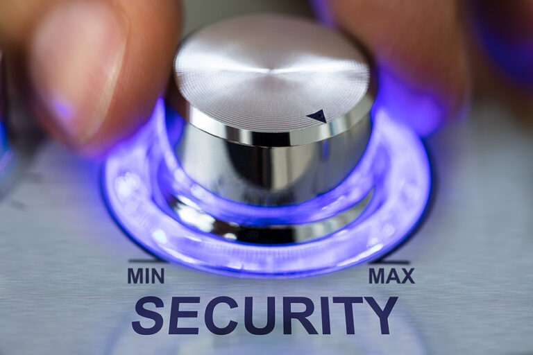 Image of hand turning metallic illuminated knob by security text