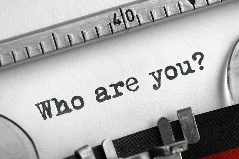 "Who are you?" typed onto a pblank page using a typewriter