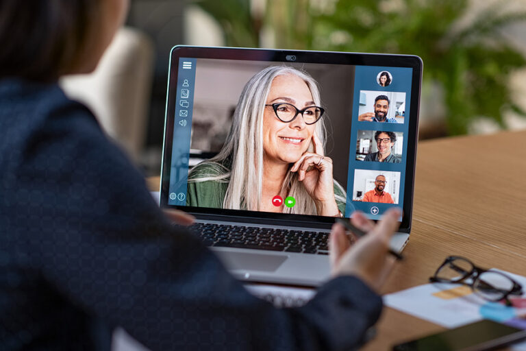 Person working from home on laptop in a video conference.