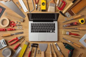 Computer surrounded by DIY tools.