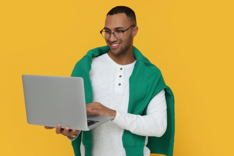 Young Marketing Intern Holds Laptop