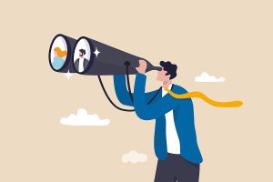 Man searching for his ideal customers through a pair of binoculars, and finds two that fit his company's avatar.